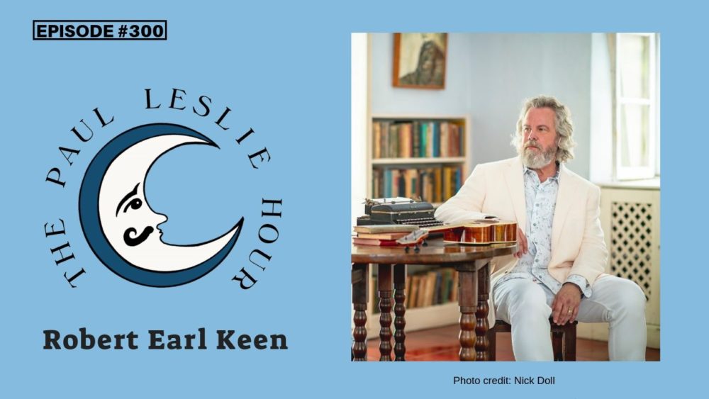 Robert Earl Keen is shown seated at a table with The Paul Leslie Hour logo nearby.